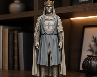 May include: A standing figurine of a king wearing a metallic crown, a light beige hooded cape, and a grey tunic featuring a Jerusalem cross emblem on the chest. The figure has a stone-like facial texture and wears matching grey boots with lacing.