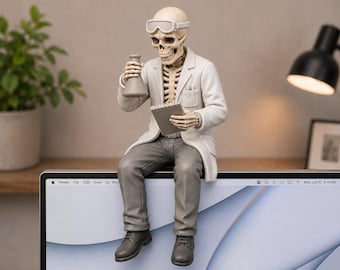 May include: A skeleton figurine dressed as a scientist, wearing a white lab coat, gray trousers, and safety goggles. The figure holds a small glass flask in one hand and a notepad in the other, sitting perched on the top edge of a computer monitor.