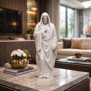 May include: A white statue of a robed figure with long hair and a beard, standing with one hand on the chest. The statue is placed on a marble-topped coffee table. The background includes a living room with a television and a sofa.
