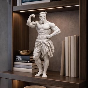 May include: A white marble statue of a muscular man flexing his bicep. The statue is draped with a cloth and has a beard. It is displayed on a dark wooden shelf with books and a gold bowl.