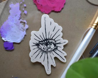Sello adhesivo de linograbado con forma de ojo de estrella