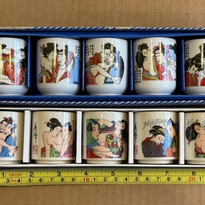 Two sets of Japanese and Korean Shunga Sake cups