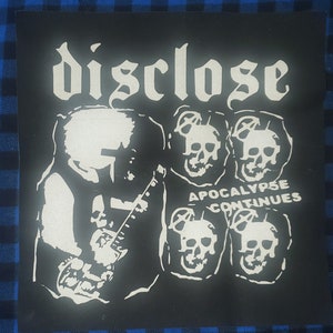 May include: Black and white patch with the band name "Disclose" in a gothic font. The patch features a skeleton playing a guitar with the text "Apocalypse Continues" below.