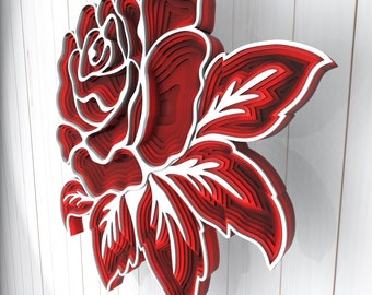 May include: A red and white layered paper rose with a 3D effect. The rose is made of multiple layers of paper, creating a dimensional look.