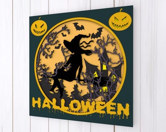 May include: A yellow and black Halloween-themed papercraft with a silhouette of a witch flying on a broomstick in front of a full moon. The text "HALLOWEEN" is written in yellow dripping letters.