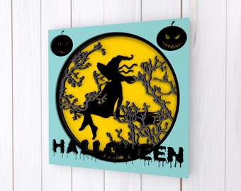 May include: A black silhouette of a witch flying on a broomstick in front of a yellow full moon with black tree branches. The background is a light blue color with the word "HALLOWEEN" in black dripping letters.