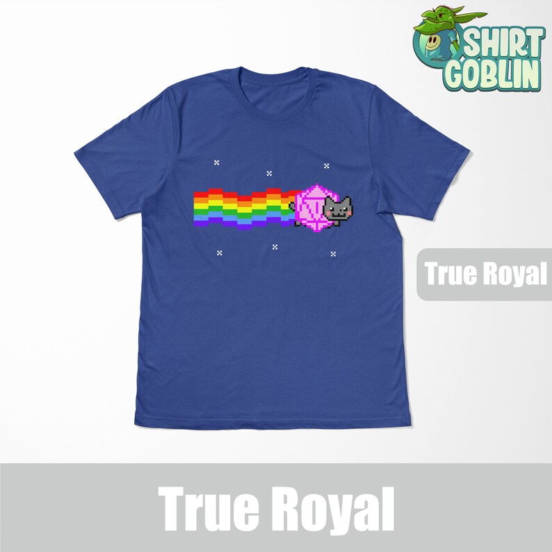 May include: A blue t-shirt with a pixelated rainbow and a cat holding a pink dice. The text "True Royal" is printed on the shirt.