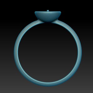 May include: A simple silver ring with a round, flat top. The ring is smooth and has a polished finish.