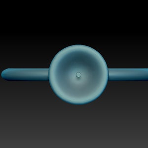 May include: A blue ceramic whistle with a round, slightly concave top and a small hole in the center.