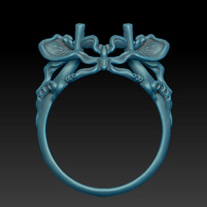 May include: A silver ring with a butterfly design. The butterfly's wings are detailed and intricate, and the ring is a delicate piece of jewelry.