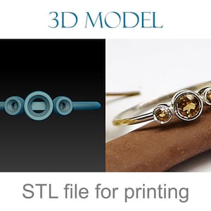 May include: A 3D model of a ring with three round stones. The ring is silver and the stones are a light brown color. The image also shows a physical version of the ring on a brown surface. STL file for printing.
