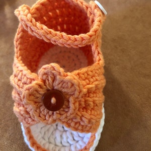 Super cute baby sandals in different designs. In orange, crocheted with flower or in pink with heart button made of cool soft cotton. image 2