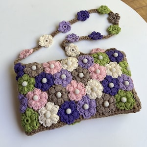 Floral handbag with beads crocheted from cotton in different variations.