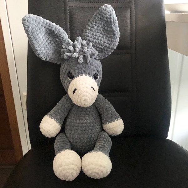Pretty donkey, cuddly toy made of soft chenille wool, head, arms and legs movable, with safety eyes. A donkey to love.