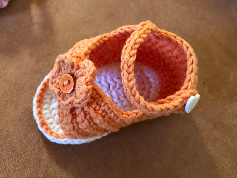 Super cute baby sandals in different designs. In orange, crocheted with flower or in pink with heart button made of cool soft cotton. image 3