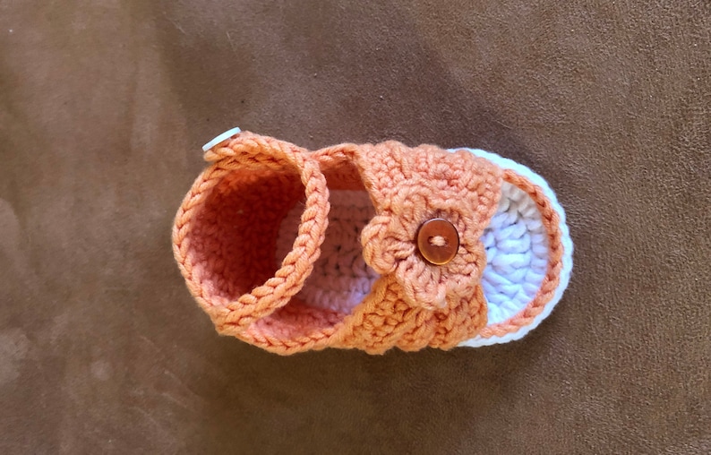 Super cute baby sandals in different designs. In orange, crocheted with flower or in pink with heart button made of cool soft cotton. image 1