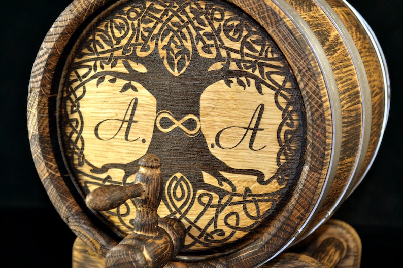 May include: A wooden barrel with a Celtic knot design and the initials "A." and "A." on either side of an infinity symbol. The barrel has a metal band around it and a wooden spigot.