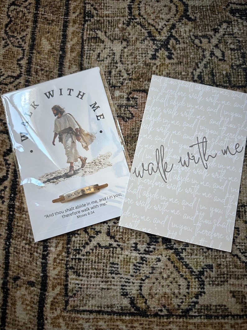 May include: Two cards and a small rolling pin with the text "Walk With Me". One card features an image of Jesus walking, with the words "Walk With Me" in a circle. The other card has the words "Walk With Me" in script.