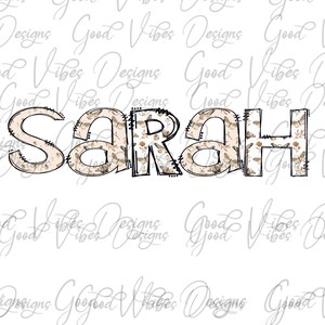 May include: The name "SARAH" is written in large, stylized letters with a brown and white floral pattern. The letters are outlined in black and have a stitched effect.