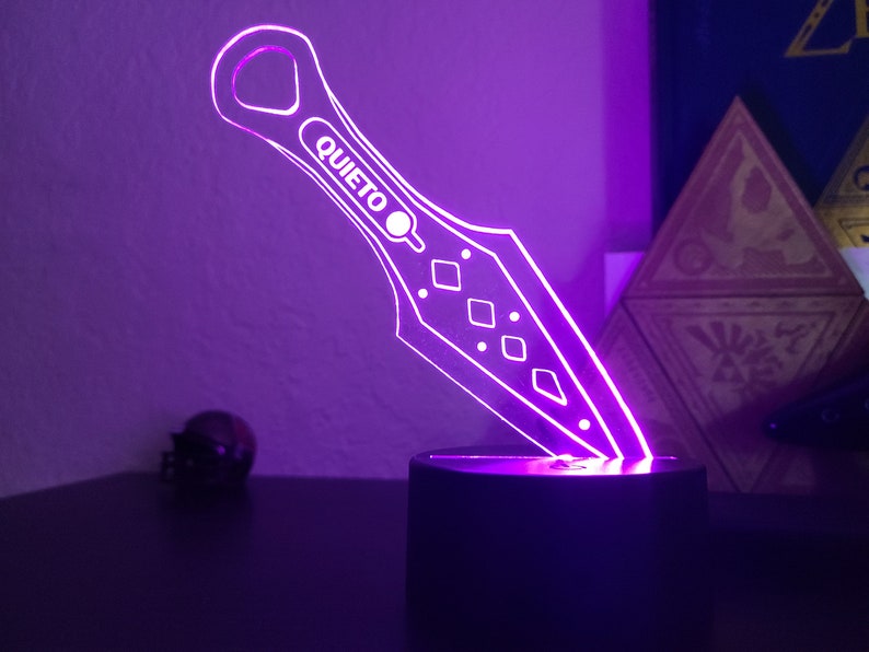 May include: A purple LED light shaped like a throwing knife with the word "QUIETO" on the blade.