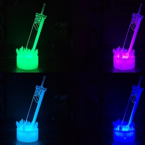 May include: A 3D printed sword with a crystal base, illuminated in four different colours: green, purple, blue, and light blue.