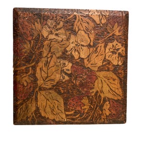 May include: Square wooden box with a carved design of strawberries and leaves. The strawberries are red, and the leaves are shades of brown and tan. The box has a dark brown border.