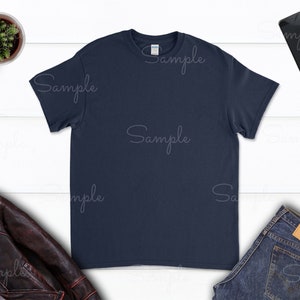 May include: A navy blue t-shirt with short sleeves and a crew neck.