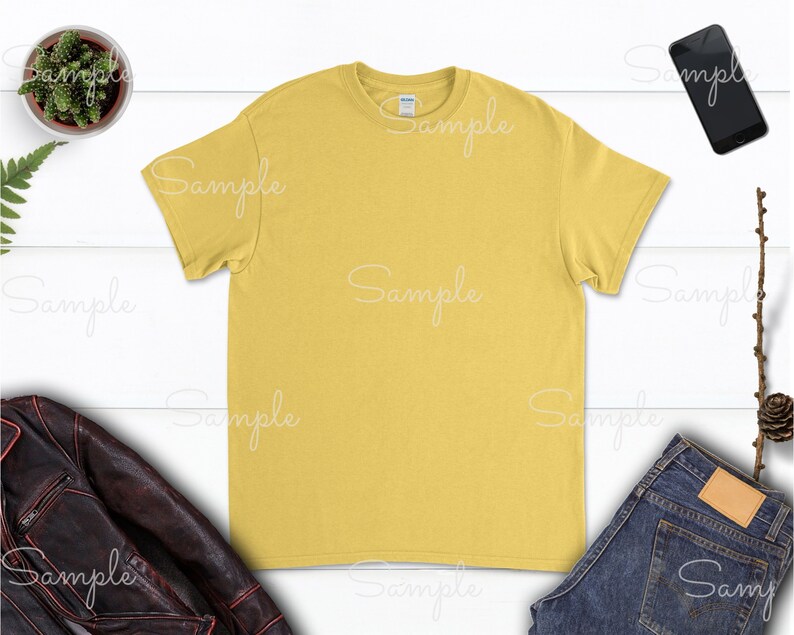 May include: A plain yellow t-shirt with a crew neck. The t-shirt is laying flat on a white surface.