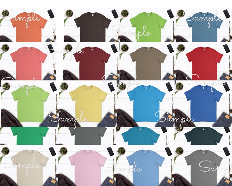 May include: A collection of 18 blank t-shirts in various colors, including coral, brown, maroon, yellow, green, blue, teal, gray, pink, and beige. The shirts are laid out on a white surface with a few decorative items around them.