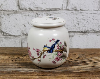 Vintge ginger jar with 2 birds in flowering cherry tree.