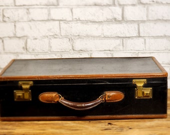 Vintage luggage, black and brown leather suitcase. Circa 1950's