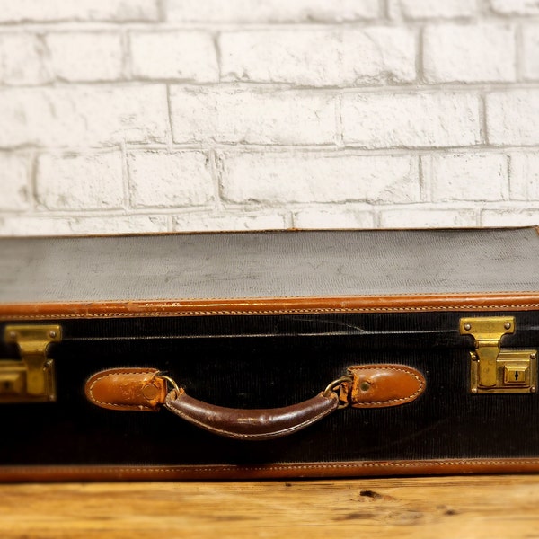 Vintage luggage, black and brown leather suitcase. Circa 1950's