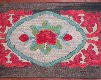 Vintage Floral Hooked Rug, with red rose in center followed by a teal border red and orange floral on brown background