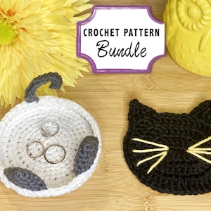 May include: Crochet pattern bundle featuring two cat-themed designs: a white cat dish with gray ears and a black cat coaster with yellow whiskers. The sign reads "Crochet Pattern Bundle".