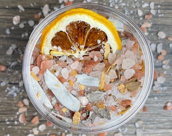 May include: A clear glass jar filled with pink Himalayan salt, dried orange peel, and other natural ingredients.