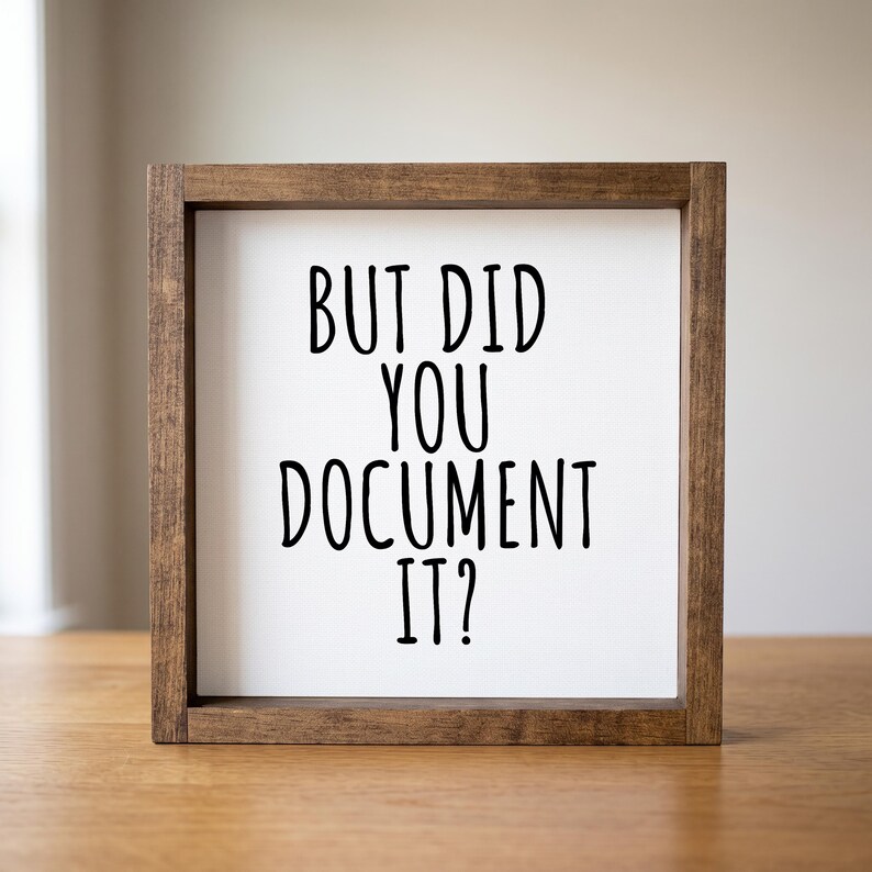 Close-up of the brown wood frame and tall black lettering reading “But Did You Document It?” on a light background.