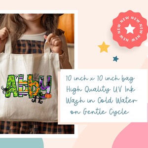 May include: A white canvas tote bag with the name "Abby" written in colorful letters with Halloween-themed designs. The bag is 10 inches by 10 inches and is made with high quality UV ink. The text on the bag reads "Wash in Cold Water on Gentle Cycle".