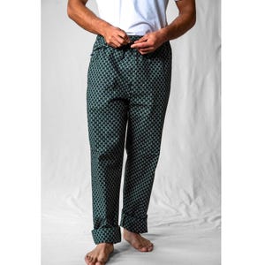 May include: Green and black patterned trousers with a drawstring waist.
