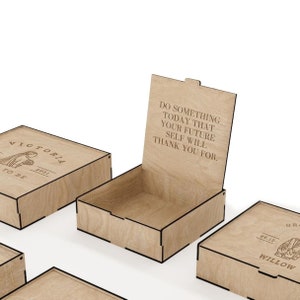 May include: Four wooden boxes with engraved text. The boxes are closed except for one, which is open to reveal an empty interior. The text on the boxes reads "Victoria 2021 To Be", "Do something today that your future self will thank you for." and "Willow 09.12 GR".