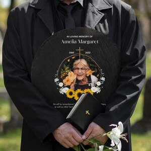 Peut inclure: Une plaque commémorative en ardoise noire avec un cadre doré et une photo d'une femme souriante. La plaque porte l'inscription "IN LOVING MEMORY OF Amelia Margaret 1950 2022".