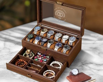 May include: A wooden watch box with a glass top and a drawer. The box has 18 slots for watches and the drawer has compartments for jewellery. The box is engraved with the text "To My Husband, Happy Anniversary, Love Always, Your Wife".
