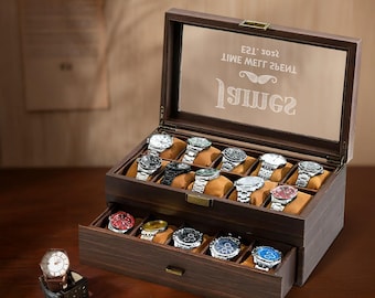 May include: A dark brown wooden watch box with a glass top and a drawer. The box has a label that reads "EST. 2022 TIME WELL SPENT 19MM2". The box is filled with watches.