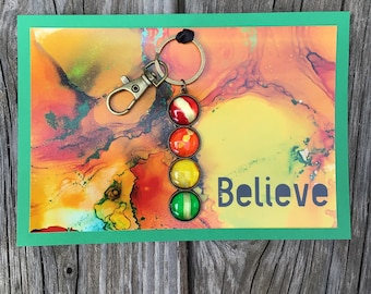 Keychain with four colorful glass cabochons