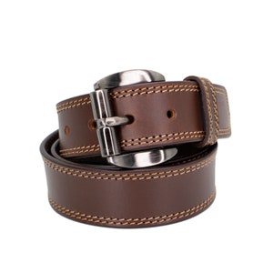 May include: A brown leather belt with a silver buckle and stitching. The belt is rolled up and the buckle is visible.