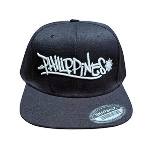 Philippines Graffiti  Snapback Hat – Street Style Embroidered Cap with Sun Emblem | Filipino Pride | Black Flat Brim with White 3D puff