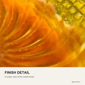 Close view of the finish, showing how the orange fan swirl reads through the translucent yellow resin.