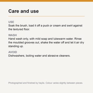 Care and use card: soak the brush and swirl against the textured floor, hand wash with mild soap, rinse the grooves and air dry, and avoid dishwashers, boiling water and abrasive cleaners.