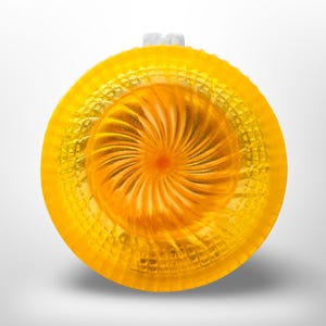 Top down view of a bright yellow resin shaving bowl with an orange fan swirl well at the centre and a waffle cut pyramid texture around the outer wall.