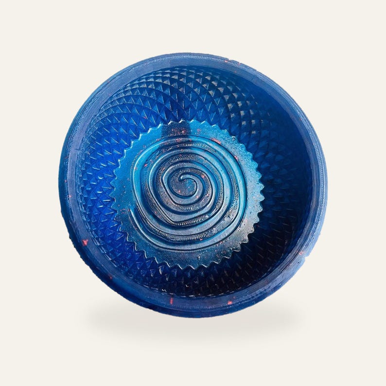 Royal blue sparkle shaving bowl on a warm off-white background, standing upright so the raised spiral coil in the floor and the moulded diamond wall are both visible.