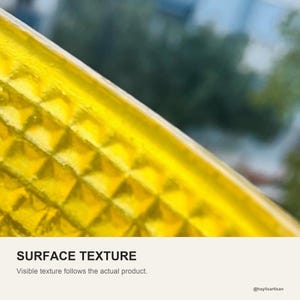 Surface texture of the yellow resin wall, the waffle cut grid running around the outside of the bowl.